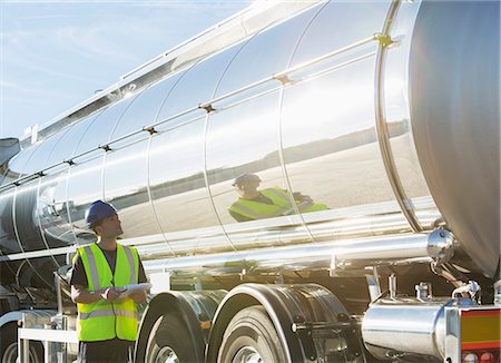 stainless steel reflection - Worker with clipboard checking stainless steel milk tanker Stock Photo - Premium Royalty-Free, Code: 6113-07565424