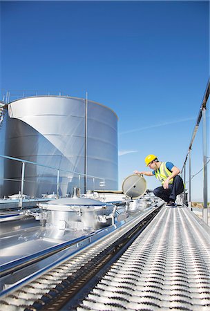 simsearch:6113-07565377,k - Worker on platform above stainless steel milk tanker Stock Photo - Premium Royalty-Free, Code: 6113-07565436