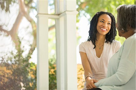 family outside ethnic - Happy mother and daughter talking on porch Stock Photo - Premium Royalty-Free, Code: 6113-07565541