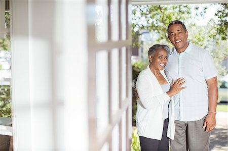 Portrait of smiling senior couple in doorway Stock Photo - Premium Royalty-Free, Code: 6113-07565578