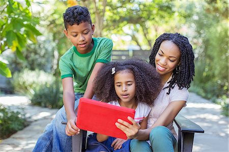 Mother and children using digital tablet outdoors Stock Photo - Premium Royalty-Free, Code: 6113-07565536