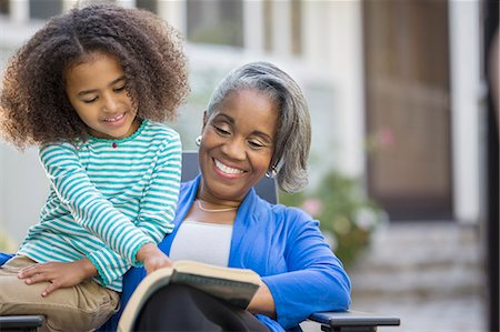 simsearch:6113-06626338,k - Grandmother and granddaughter reading book on patio Stock Photo - Premium Royalty-Free, Code: 6113-07565612