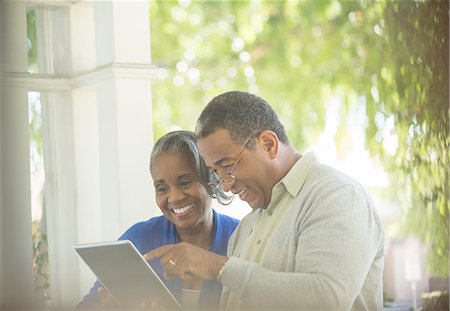 Happy senior couple using digital tablet on porch Stock Photo - Premium Royalty-Free, Code: 6113-07565635