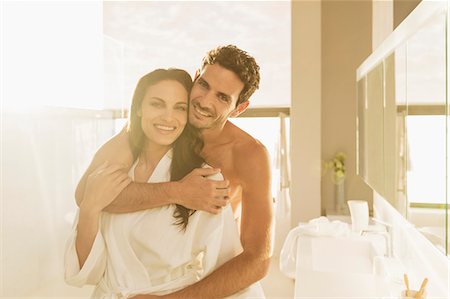 people embracing - Portrait of couple hugging in bathroom Stock Photo - Premium Royalty-Free, Code: 6113-07565763