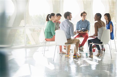 Creative business people meeting in circle of chairs Stock Photo - Premium Royalty-Free, Code: 6113-07565842
