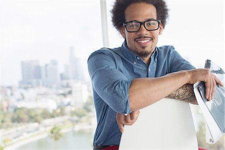 eyeglasses people smiling - Portrait of confident businessman holding folder Stock Photo - Premium Royalty-Free, Code: 6113-07565849