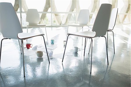 simsearch:6113-07565851,k - Coffee cups and paperwork at circle of chairs Stock Photo - Premium Royalty-Free, Code: 6113-07565851