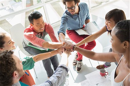 people huddling - Creative business people connecting hands in huddle Stock Photo - Premium Royalty-Free, Code: 6113-07565856