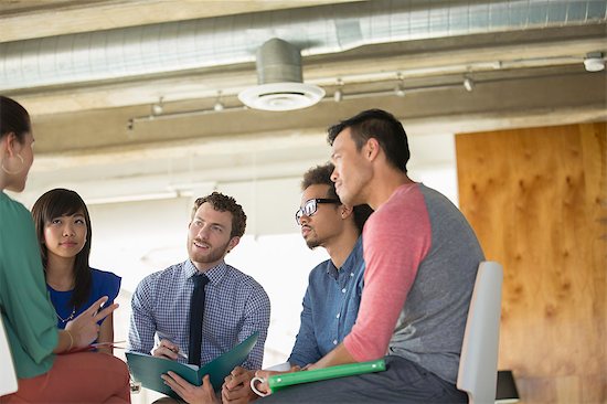 Creative business people meeting in circle of chairs Stock Photo - Premium Royalty-Free, Image code: 6113-07565971