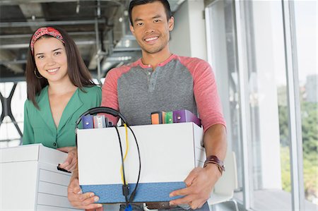 people moving boxes - Portrait of happy casual business people carrying boxes of belongings in office Stock Photo - Premium Royalty-Free, Code: 6113-07565979