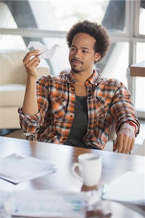 food selective focus - Pensive creative businessman looking at origami swan in office Stock Photo - Premium Royalty-Free, Code: 6113-07565905