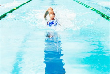 Swimmer racing in pool Stock Photo - Premium Royalty-Free, Code: 6113-07588652