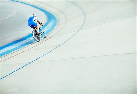 simsearch:6113-07588815,k - Track cyclist riding around velodrome Fotografie stock - Premium Royalty-Free, Codice: 6113-07588635