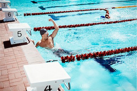 swimmers in pool from above - Swimmer celebrating in pool Stock Photo - Premium Royalty-Free, Code: 6113-07588638