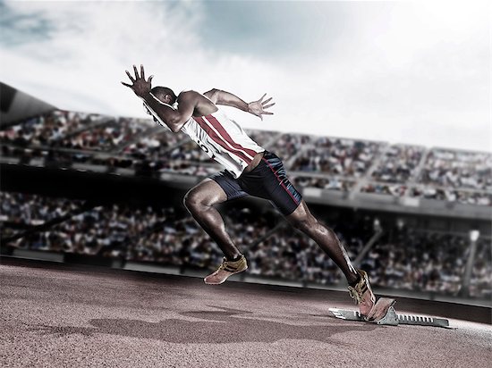 Runner taking off from starting block on track Stock Photo - Premium Royalty-Free, Image code: 6113-07588760