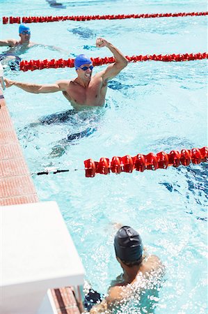 Swimmer celebrating in pool Stock Photo - Premium Royalty-Free, Code: 6113-07588783