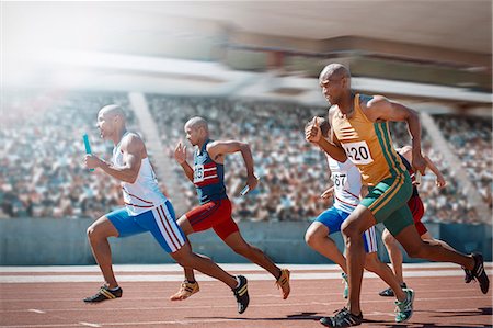 simsearch:6113-07588701,k - Relay runners racing on track Stock Photo - Premium Royalty-Free, Code: 6113-07588786