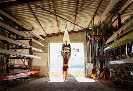 rowing crew and overhead - Rowing team carrying scull into shed Stock Photo - Premium Royalty-Free, Code: 6113-07588792