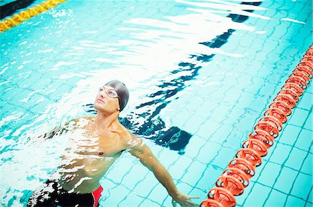 swimmers in pool from above - Swimmer on back in pool Stock Photo - Premium Royalty-Free, Code: 6113-07588700