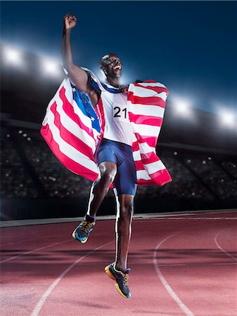 runner from below - Runner holding American flag and celebrating on track Stock Photo - Premium Royalty-Free, Code: 6113-07588719