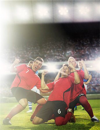 soccer stadium low angle shot - Soccer team celebrating on field Stock Photo - Premium Royalty-Free, Code: 6113-07588856