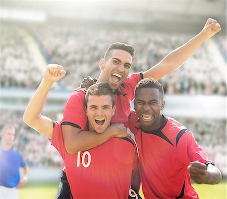 simsearch:858-08421632,k - Soccer players celebrating on field Photographie de stock - Premium Libres de Droits, Code: 6113-07588875