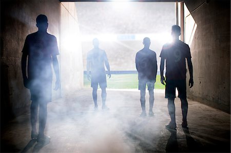 sports stadium flare - Silhouette of soccer teams facing field Stock Photo - Premium Royalty-Free, Code: 6113-07588836