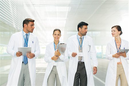 simsearch:6113-06498892,k - Doctors walking in hospital corridor Stock Photo - Premium Royalty-Free, Code: 6113-07588990