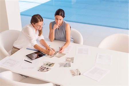 Businesswomen meeting at conference table Stock Photo - Premium Royalty-Free, Code: 6113-07588911