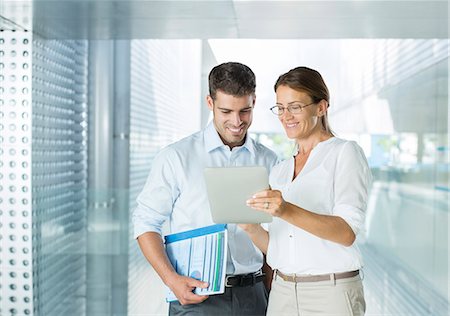 Business people using digital tablet in office Stock Photo - Premium Royalty-Free, Code: 6113-07588934