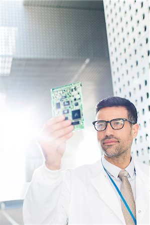 future technology - Engineer examining circuit board Photographie de stock - Premium Libres de Droits, Code: 6113-07589041