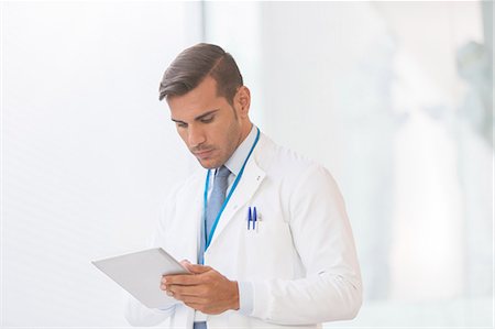 doctor holding digital tablet - Doctor using digital tablet Stock Photo - Premium Royalty-Free, Code: 6113-07589028