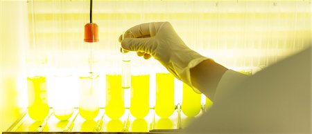 Scientist examining test tubes with green liquid Stock Photo - Premium Royalty-Free, Code: 6113-07589198