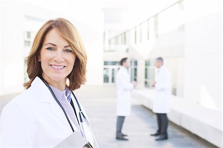 full body image of person in lab coat - Portrait of smiling doctor Stock Photo - Premium Royalty-Free, Code: 6113-07589239