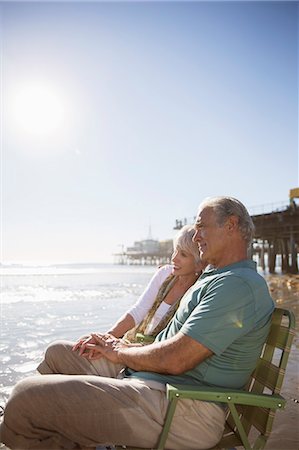 simsearch:6113-07564959,k - Senior couple relaxing in lawn chairs on beach Stock Photo - Premium Royalty-Free, Code: 6113-07589343