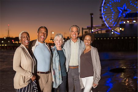 Portrait of senior friends on beach at night Stock Photo - Premium Royalty-Free, Code: 6113-07589360
