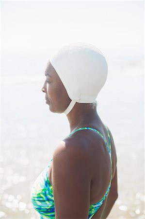 swim cap females - Pensive woman in bathing suit and cap Stock Photo - Premium Royalty-Free, Code: 6113-07589376