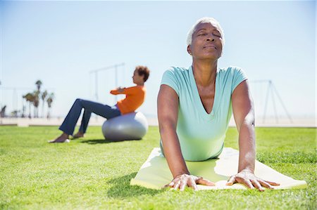 simsearch:6113-07906163,k - Women practicing yoga in sunny park Stock Photo - Premium Royalty-Free, Code: 6113-07589390