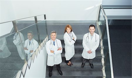 simsearch:6113-07589273,k - Portrait of confident doctors on stairs Stock Photo - Premium Royalty-Free, Code: 6113-07589300