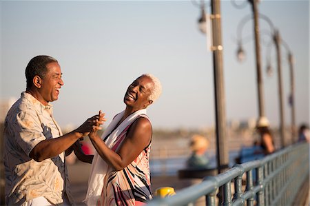 seniors dancing outside - Senior couple dancing on pier Stock Photo - Premium Royalty-Free, Code: 6113-07589438