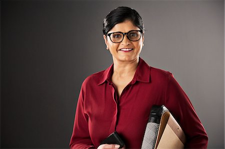 portrait of a woman smiling indian - Portrait of confident businesswoman Stock Photo - Premium Royalty-Free, Code: 6113-07648695