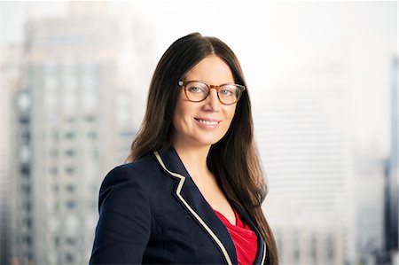 eyeglasses travel - Portrait of confident businesswoman in urban window Stock Photo - Premium Royalty-Free, Code: 6113-07648703