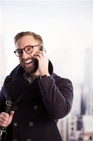 Happy businessman talking on cell phone Stock Photo - Premium Royalty-Free, Code: 6113-07648706