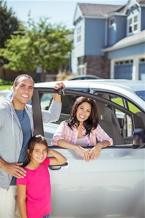 Portrait of smiling family at car in driveway Foto de stock - Sin royalties Premium, Código: 6113-07648831