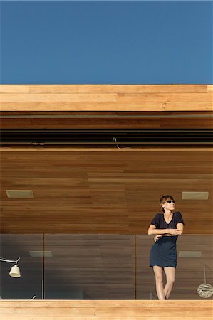 simsearch:6113-07648969,k - Woman standing on luxury balcony Stock Photo - Premium Royalty-Free, Code: 6113-07648964