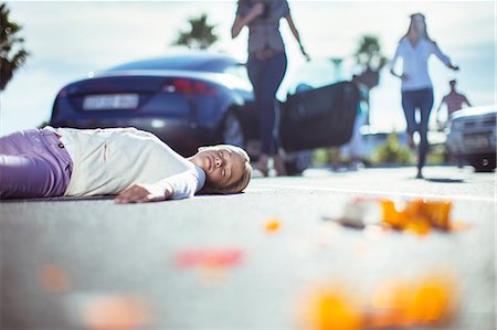 people lying down on the road - Driver rushing to injured girl on street Stock Photo - Premium Royalty-Free, Code: 6113-07761944