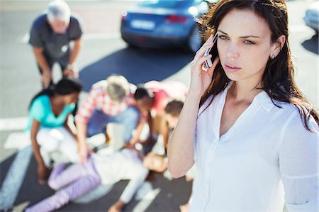 Woman calling emergency services at car accident Stock Photo - Premium Royalty-Free, Code: 6113-07761959
