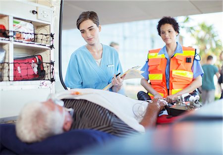 Paramedic and nurse examining patient in ambulance Fotografie stock - Premium Royalty-Free, Codice: 6113-07761986