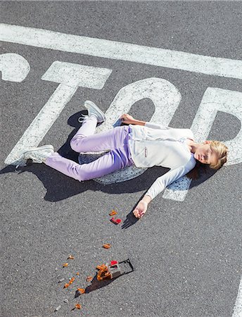 parking lot overhead - Injured girl laying in street Stock Photo - Premium Royalty-Free, Code: 6113-07761988