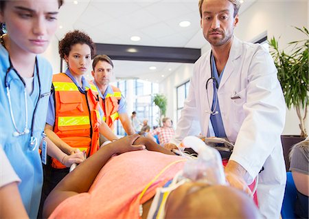 Doctor, nurses and paramedics examining patient in hospital Foto de stock - Sin royalties Premium, Código: 6113-07761997